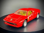 Miniatura Ferrari 288 GTO  M.C. Toy, Ferrari 288 GTO, icónico superdesportivo clássico em tom vermelho vivo (Rosso Corsa), com tejadilho característico, entradas de ar laterais, chapa traseira com a inscrição "GTO" e emblemas do Cavallino Rampante aplicados nas laterais e no capot.   Fabricante: M.C. Toy (Made in Macau, gravado na base). Med. 03x11x03 cm. Marcas do tempo e de uso.