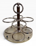 PORTA-COPOS GIRATÓRIO em madeira, metal prateado e base em acrilico translúcida, de elegante desenho decorativo. Mede 26 cm de altura x 23 cm de diâmetro.