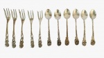 Lote com onze peças em metal espessurado a prata, sendo cinco garfos e seis colheres com pegador trabalhado em tema de flor. Medida: Comprimento 14 cm 