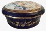 ECHT COBALT 24 KARAT- Potiche em porcelana pintado artesanalmente em tema de anjos com detalhes em dourado. Medidas: Altura 10 cm, Largura 16 cm e Comprimento 20 cm. 