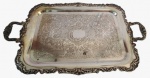 Bandeja em metal espessurado a prata com borda e centro trabalhado. Obs: necessita de restauro como mostra a foto. Medida: 35x62. 
