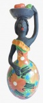 Escultura em barro com pintura artesanal representando uma mulher. Medida: altura 24 cm diâmetro 10 cm.