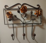 Cabideiro em ferro fundido com flores na tonalidade laranja. Medida: altura 42 cm largura 15 cm comprimento 12 cm. 