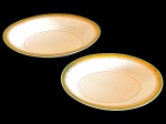 BRENNAND. Duas saladeiras em porcelana nacional esmaltada na cor branca, decorada com faixa verde e rica ornamentação em ouro, composta por frisos e motivos fitomorfos. Manufatura marcada no verso. Medidas: 5,5 x 32 x 21 cm e 5 x 27 x 18 cm.