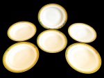 BRENNAND. Seis pratos fundos em porcelana nacional esmaltada na cor branca, decorada com faixa verde e rica ornamentação em ouro, composta por frisos e motivos fitomorfos. Manufatura marcada no verso. Medidas: 4 x 24,5 cm.
