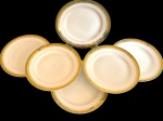 BRENNAND. Seis pratos rasos em porcelana nacional esmaltada na cor branca, decorada com faixa verde e rica ornamentação em ouro, composta por frisos e motivos fitomorfos. Manufatura marcada no verso. Medidas: 24,5 cm. Um com leves desgates na borda.