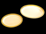 BRENNAND. Duas travessas em porcelana nacional esmaltada na cor branca, decorada com faixa verde e rica ornamentação em ouro, composta por frisos e motivos fitomorfos. Manufatura marcada no verso. Medidas:  22,5 x 15,5 cm e  28 x 18,5 cm.