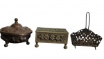Conjunto de 3 antigas peças decorativas em metal, composto por duas caixas com tampa, ornamentadas em relevo com motivos florais e vegetalistas, e um porta-cartas/porta-guardanapos, com estrutura vazada e ricamente trabalhada. Peças apresentam desgaste do acabamento, necessitando novo banho. Medidas: 17 x 13 x 4 cm / 14,6 x 10 x 7,5 cm / 14,5 x 13 cm.