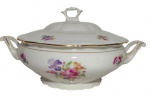 Tielsch Walbrzych, Polonia. Antiga sopeira em porcelana,com alças laterais vazadas e tampa com puxador recortado. Decorada com buquês florais policromados, destacando rosas e íris, com delicados filetes dourados nas bordas e alças. Medidas: 29 x 22 x 16 cm.
