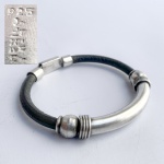 Pulseira modernista em prata contrastada teor 925 e couro, fecho gaveta. Med interna 6 cm.