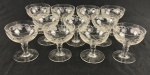 Conjunto de 11 taças para coquetel em cristal europeu translúcido, com bojos decorados por folhas de parreira fosqueadas, cachos de uvas gravados e delicadas linhas onduladas. Hastes moldadas e bases circulares.  Medidas: 7,5 x 7 cm.