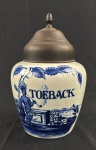 Tabaqueira em porcelana Holandesa azul e branca , porcelana Delfs Blaun, marca "Zenith Gouda", com tampa de metal, bom estado de conservação.Medindo: 25 x 16 cm