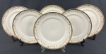 IVORY CHINA BY PORCELANA SCHMIDT BRASIL, Roberto Simões. Conjunto de 6 pratos rasos em porcelana marfim esmaltada, com faixa decorativa policromada de motivos florais e arabescos, emoldurada por largas bordas douradas. Manufatura e assinatura identificadas no verso. Medindo: 25,5 cm.