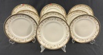 IVORY CHINA BY PORCELANA SCHMIDT BRASIL, Roberto Simões. Conjunto de 9 pratos para sobremesa em porcelana marfim esmaltada, com faixa decorativa policromada de motivos florais e arabescos, emoldurada por largas bordas douradas. Manufatura e assinatura identificadas no verso. Medindo: 19 cm. 2 com bicados.
