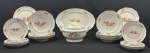 Parte de serviço para jantar, em porcelana nacional da marca STEATITA, decoração floral em policromia, frisos prateados: onze pratos rasos, nove fundos, oito para sobremesa, sopeira e travessa. Total 30 peças. Frisos com perdas no prateamento. Marca do fabricante. Medindo: 24 cm, 5 x 23 cm, 19 cm, 22 x 30 cm e 35 x 38 cm.