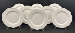 CERÂMICA LUIZ SALVADOR, ITAIPAVA. Conjunto de oito pratos rasos em cerâmica branca esmaltada, feitos à mão, com bordas recortadas, filetadas e discretos relevos. Marca do fabricante na base. Medidas: 27 cm de diâmetro, 2 com peq fio de cabelo, sendo um de fabricação.