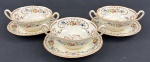 Royal Doulton -  Três consumes em faiança inglesa, esmaltado com policromia de flores, detalhes ornamentais em marrom e filete amarelado.