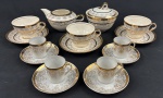 Conjunto para chá e café em faiança, decorados cenas campestres e figuras em trajes de época ao centro, cercadas por delicada decoração floral e rica douração, marcado no verso. Sendo Bule sem tampa, açucareiro, três xicaras de chá com  pires e quatro para café com pires. Medindo respectivamente: 8 x 16 x 12 cm e 12 x 12 cm.