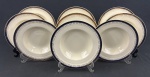 GRINDLEY - Nove pratos fundos em faiança inglesa no tom creme, com decoração geométrica, filete em azul cobalto e detalhes em ouro.  Medindo: 4 x 23 cm. Um com bicado.