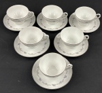 Seis xicaras para chá  porcelana japonesa na cor branca, esmaltado com delicada decoração floral e filetes prateados.