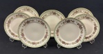 Schmidt, Ivory China - Sete pratos para sobremesa em porcelana na cor marfim, esmaltado com policromia de flores, listra verde e filete dourado. Medindo: 19 cm.