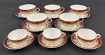 Schmidt. Cinco xícaras para chá e 3 para café em porcelana branca, com larga faixa furta-cor, borda em tom vinho e profusa ornamentação dourada. Manufatura no verso.