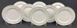 Schmidt, Voyage. Oito pratos para sobremesa em porcelana esmaltada na cor branca, borda decorada e filetes em prata. Manufatura no verso. Medindo: 19,5 cm..