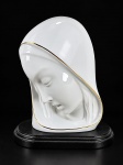 ARTE SACRA, uma (1) imaginária representando Madonna, em porcelana chilena na tonalidade branca, representando Nossa Senhora com semblante sereno e véu, com delicados filetes dourados, apoiada sobre base preta. Marcada no verso Madonna  Florencia  Made in Chile  Edición Limitada 1990  Hecho a Mano, apoiada sobre base oval em resina preta, medindo 19cm de altura.