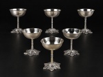 METAL PRATEADO, seis (6) taças para sobremesa confeccionadas em metal espessurado a prata , bojo liso, haste cilíndrica decorada por esferas, apoiada sobre base recortada no feitio de flor, banho novo, medindo 9,5x7,5cm.
