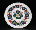 PORCELANA SCHMIDT, um (1) prato para bolo confeccionado em porcelana na tonalidade branca, decorado por flores e folhagens em policromia, medindo 31cm de diâmetro.