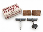 AUTOMOBILISMO, um (1) kit de reparo para pneus sem câmara SAFETY SEAL, composto por ferramentas manuais metálicas com cabos em T e tiras de reparo/vulcanização, acondicionado em caixa original. Conjunto destinado a reparos emergenciais em pneus tubeless. Apresenta sinais de uso, oxidação e desgastes compatíveis com a idade e armazenamento. Conteúdo não conferido quanto à completude. Peças no estado.