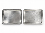 CHRISTOFLE, duas (2) bandejas retangulares confeccionadas em metal francês espessurado a prata, sendo: A) 1 com fundo liso e bordas em caneluras, medindo 43x33cm e B) 1 com fundo cinzelado por 15 receitas clássicas de drinques (como Manhattan, Dry Cocktail, Daiquiri, Side Car, entre outros), apresenta pontos de oxidação, medindo 43,5x33,5cm.