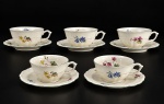 Carl Tielsch & Co., cinco (5) xícaras para chá com seus respectivos pires confeccionadas em porcelana alemã na tonalidade creme, decorada por elementos florais e vegetalistas em policromia, realces em relevo na pasta e borda com filete verde, medindo 5x12x9,5cm.