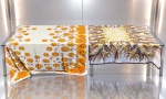 CAMA, MESA & BANHO, duas (2) toalhas de mesa em tecido estampado, sendo: A) uma (1) em fundo claro, decorada com motivos florais em tons de amarelo, laranja e marrom, com barrado ornamental de arabescos, medindo 244x158cm, apresenta manchas e B) uma (1) em fundo claro, apresentando estampa floral em policromia, medindo 170x170, marcas de uso.