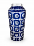 CRISTAL DOUBLE, um (1) vaso confeccionado em cristal double na tonalidade azul, lapidado por esferas, estrelas e elementos quadrangulares e borda em dedões, apresentam bicados, vide foto, medindo 30x9cm.