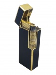 DIVERSOS, um (1) isqueiro vintage a gás, de formato retangular, em metal dourado com aplicações em laca/esmalte preto, tampa articulada e mecanismo de ignição por rolete frontal texturizado, sinais de uso, necessita revisão, medindo 6,5x2,5cm.