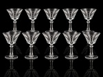 CRISTAIS, dez (10) taças para vinho confeccionados em cristais translúcidos com lapidação em caneluras, haste facetada e base circular, 6 apresentam bicados, medindo 16,5x9,5cm.