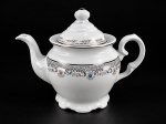 PORCELANA SCHMIDT - (1) Bule para chá em porcelana branca vitrificada ,  com decoração floral policromada e faixas ornamentais em prata. Corpo bojudo, alça curva, bico alongado e tampa com pega torneada. Base recortada  , medida : 20 cm