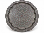 BRONZE INDIANO, uma (1) bandeja decorativa de formato circular, confeccionada em bronze indiano, borda recortada e ondulada em gomos, com compartimentos rebaixados ao longo da circunferência. Superfície ricamente ornamentada com delicados motivos florais e arabescos em composição radial, trabalhados em relevo e com detalhes em esmaltação policromada, medindo 58cm de diâmetro.