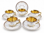PORCELANA MONTE ALEGRE, cinco (5) xícaras para chá com seus respectivos pires confeccionadas em porcelana na tonalidade branca, decorado por folhagens, filetes em ouro e faixa na tonalidade marrom, interior em vasta douração, apresentando leves falhas na douração, medindo 6x10x9cm.