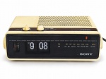 RELÓGIO, um (1) relógio despertador de mesa vintage, marca SONY DIGIMATIC, com rádio AM/FM integrado, visor de horas e minutos com sistema de palhetas mecânicas (flip clock), função despertador e temporizador Sleep. Gabinete em material sintético na cor creme, com painel frontal preto e alto-falante superior. Apresenta sinais de uso, amarelamento e marcas do tempo. Funcionamento não testado. No estado, medindo 8x23x14cm.