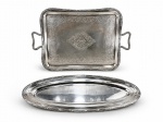 METAL PRATEADO, lote com duas (2) peças, sendo: A) WOLFF, uma (1) bandeja retangular confeccionada em metal espessurado a prata, cinzelado por elementos vegetalistas e florais, borda em recortes com caneluras, fitas cruzadas e rosinhas, alças laterais vazadas, apresentam sinais de uso e imperceptíveis mossas, medindo 51x33,5cm e B) WOLFF, uma (1) travessa para peixe confeccionada em metal espessurado a prata, borda cinzelada em caneluras e fitas cruzadas, apresenta sinais de uso, medindo 50x21cm.