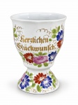 PORCELANA ALEMÃ, uma (1) taça souvenir confeccionada em porcelana na tonalidade branca com rica decoração floral em policromia e inscrição em ouro "Herzlichen Glückwunsch", medindo 12x9cm.