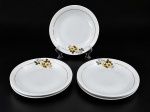 RENNER  PORTO ALEGRE, um (1) conjunto composto por 7 pratos fundos em porcelana branca vitrificada, com delicada decoração floral policromada em tons de amarelo, azul e verde, arrematados por finos frisos dourados , falhas na douração , medida : 23 cm , 1 possui bicado na borda .