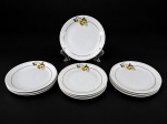 RENNER  PORTO ALEGRE, um (1) conjunto composto por 10 pratos para sobremesa em porcelana branca vitrificada, com delicada decoração floral policromada em tons de amarelo, azul e verde, arrematados por finos frisos dourados , 1 possui bicado  , medida : 18 cm