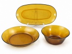 VIDROS, três (3) peças, sendo: A) 1 saladeira, medindo 8x20cm, B) 1 travessa oval, medindo 36x19cm e C) 1 tigela, medindo 5x28,5cm, confeccionados em vidro na tonalidade âmbar da manufatura DURALEX.