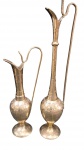 Duas jarras decorativas em metal dourado com cinzelado manual e ornamentação floral gravada, bases balústres e hastes de sustentação laterais, a peça maior apresenta a haste lateral colada, medindo 30 cm e 20 cm de altura
