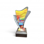 Troféu Comemorativo  Comitê Paralímpico do Cazaquistão em acrílico translúcido recortado em formato ondulado com grafismo abstrato, trazendo o símbolo dos Jogos Paralímpicos (Agitos), a bandeira do Cazaquistão e inscrições oficiais. Base quadrada em madeira escura. Medidas totais: 23 x 17 cm e Base: 5 x 11 x 11 cm. Bom estado de conservação