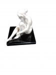 ESCULTURA EM PEDRA  figura feminina nua em posição sentada sobre base de granito negro polido. Sem assinatura visível. Medidas: Escultura: 10 x 12 cm Base: 10 x 10 cm  apresenta perna colada  e sujidade do tempo, pequeno quebrado na base.