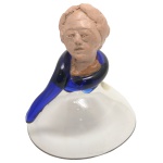 MARIO SEGUSO. Vintage  Peça de decoração de formato cônico em vidro artístico de Murano realçado por detalhe de cor azul. Parte superior ornada por cabeça masculina em cerâmica, apoiada em adorno espiralado de cor azul. Assinada. 15 x 12 cm. Passamos para informar os detalhes e o procedimento para a retirada do seu lote: O lote encontra-se originalmente em Belo Horizonte (MG). e estará disponível em nosso escritório em São Paulo (SP) a partir de uma semana após o término do leilão. A retirada deve ser feita exclusivamente mediante agendamento prévio. Telefone para agendamento: (11) 5044-1228. Por favor, entre em contato conosco pelo telefone acima para escolher o melhor dia e horário para buscar o seu lote.